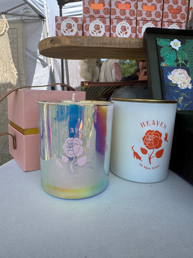 Decorative tins with floral designs on a textured surface