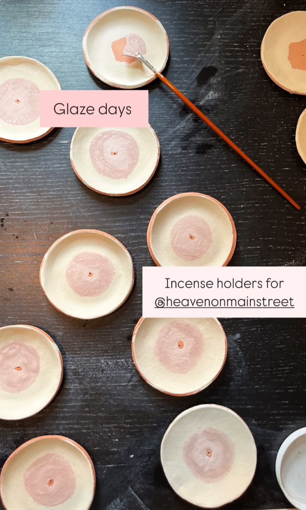 Incense holders being glazed with a brush on a wooden surface, with 'Clayground Catskills' branding.